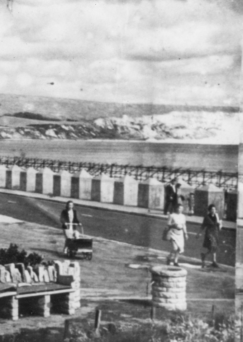 A battered image of Swanage Bay with its wartime defence. The Grand Hotel on left.