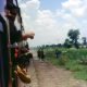 Soldiers on horseback gallop alongside the train, slowly overtaking