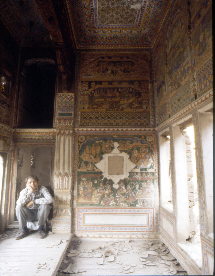 Rabu inside the Chaudhary haveli shortly before it fell. A decorative mirror and carved window surrounds have gone to market.