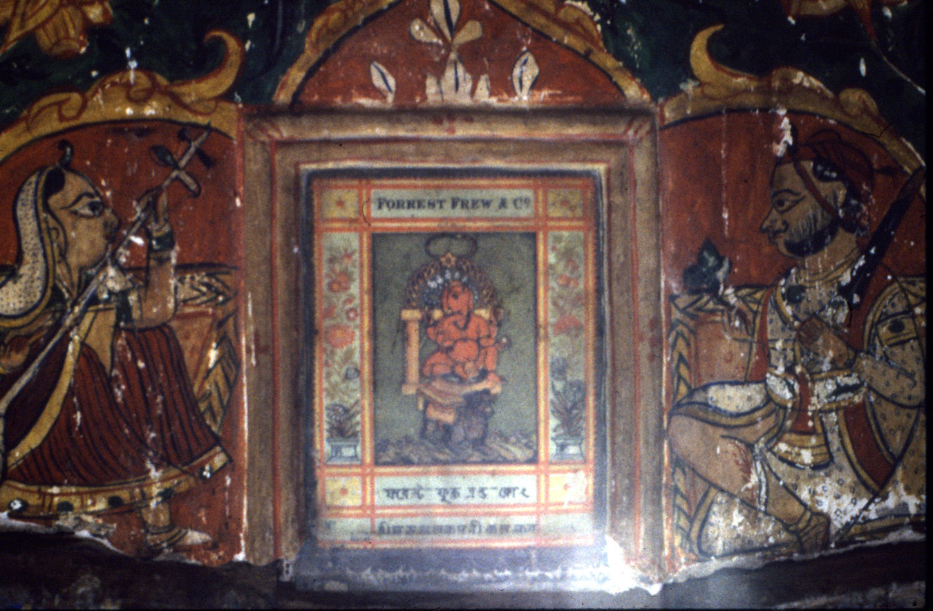 An early textile label set behind glass in an 1880s haveli wall as part of a mural decoration.