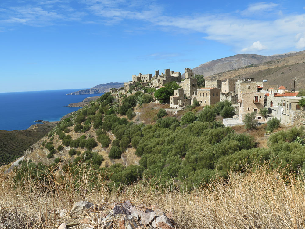 Above olive trees, Vathia overlooks the sea.